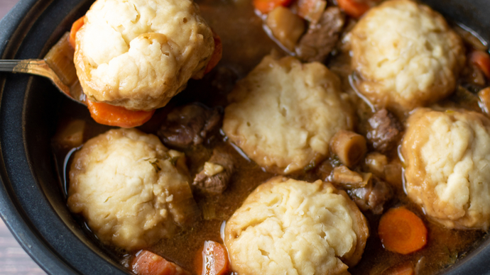 beef stew in a pot with dumplings