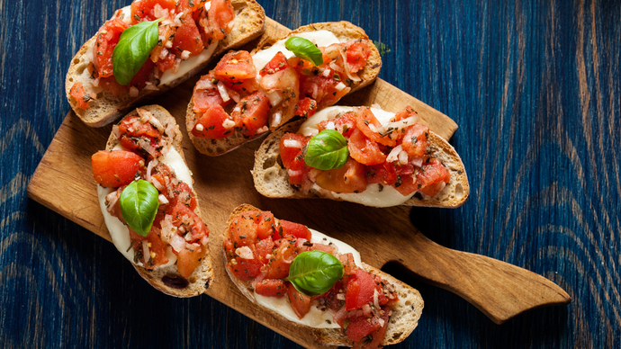 Crisp toasted bread spread with cheese and garlic tomatoes