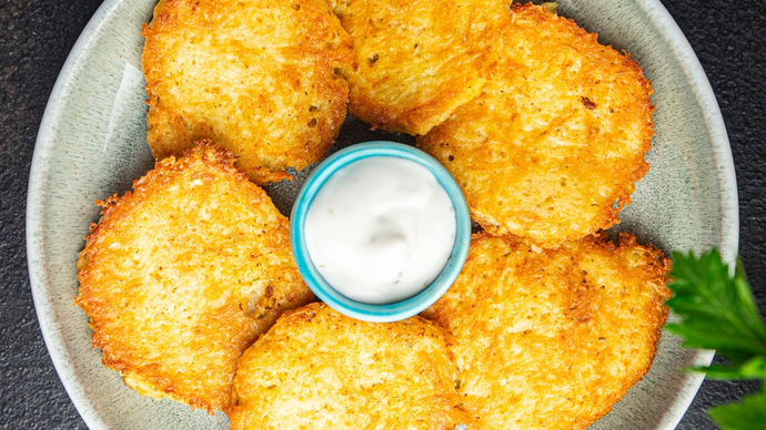 crispy hash browns circling a dipping sauce