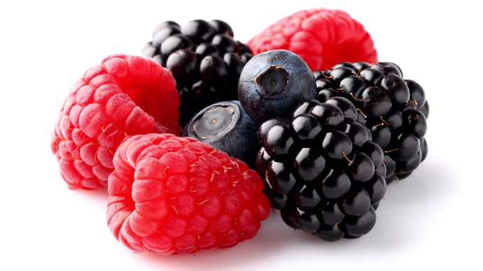 A small pile of raspberries, blueberries and blackberries