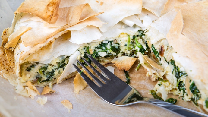 a plate of spinace and cheese filo pastry pie