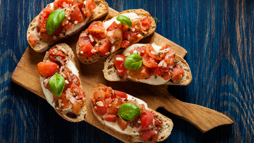 Crisp toasted bread spread with cheese and garlic tomatoes