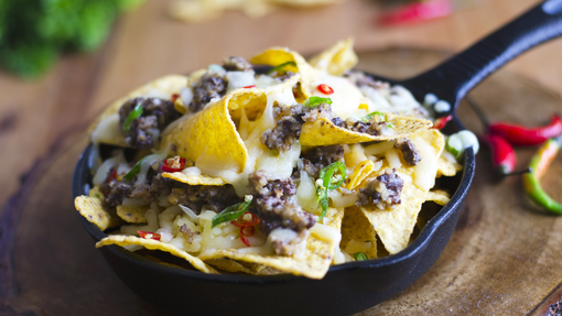 Crispy nachos covered with haggis, melted cheese and pepper slices