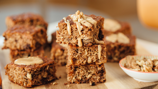 cubed pieces of rich peanut butter and banana loaf topped with baked banana slices