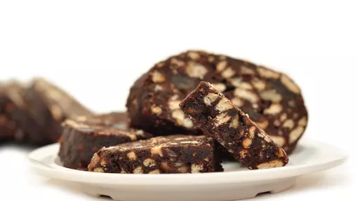 Portions of chocolatey biscuit cake dotted with walnuts and blueberries