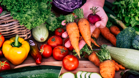 A spread of lovely fresh brightly coloured summer vegetables 