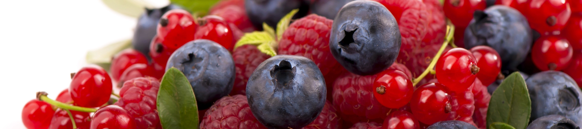 a pile of fresh summer berries - blueberries and raspberries